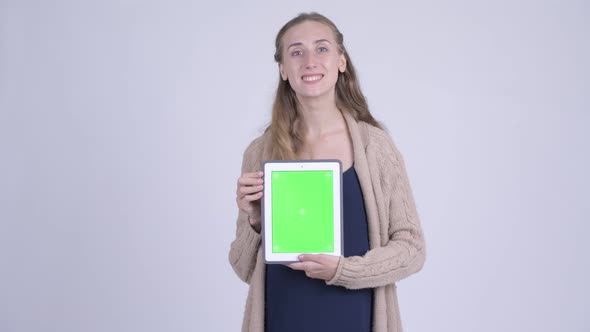 Happy Young Pregnant Woman Showing Digital Tablet