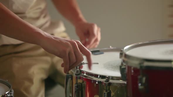 Drummer preparing snare drum, tuning it for the best sound possible before practice begins.