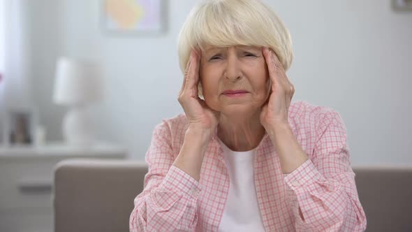 Senior Woman Massaging Temples, Feeling Migraine Pain, Health Problems