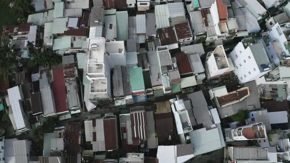 Drone Shot looking straight down over terrace house rooftops and narrow alleyways of Binh Thanh (Bìn