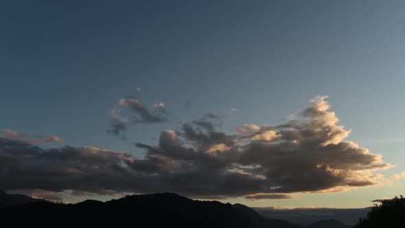 Time lapse view of clouds gathering over mountains