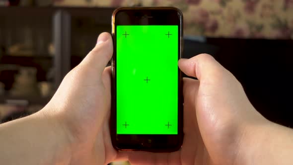 The Man Uses the Phone. Hand Makes Swipe Left on Smartphone with Green Screen. Chroma Key.