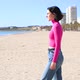 Dressed Young Woman Goes to the Sea and Looks Forward - VideoHive Item for Sale