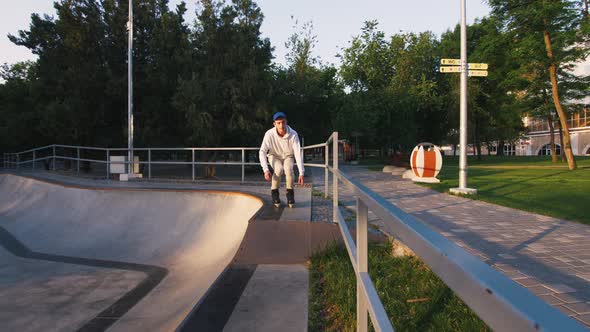 Aggressive Inline Roller Skater Doing Tricks in Concrete Skatepark Outdoors Slow Motion