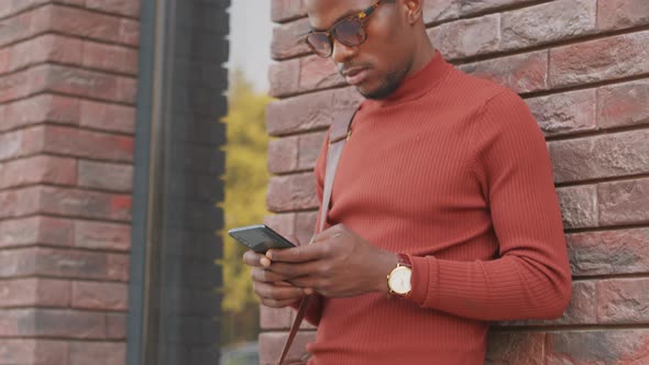 Handsome Businessman with Smartphone Outdoors