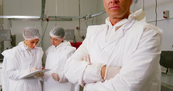 Butcher standing with arms crossed