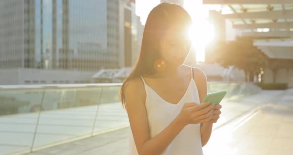 Woman use of smart phone in the evening 