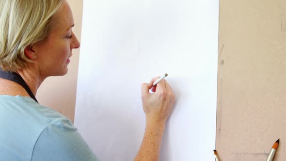 Woman drawing sketch on canvas 4k