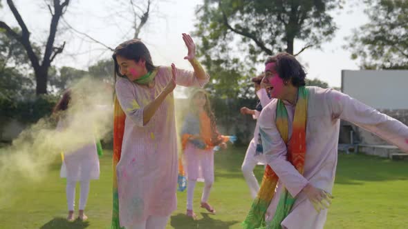 Indian man throws color on to his partner at a Holi party