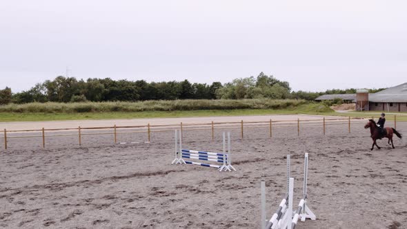 Drone Of Woman Horse Jumping Around Paddock