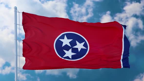 Tennessee Flag on a Flagpole Waving in the Wind Blue Sky Background