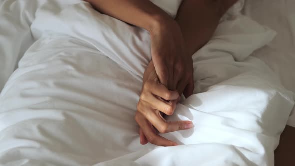 Female Hands on Bed Linen During Morning Wake Up Details Shot Sleeping at Early Morning