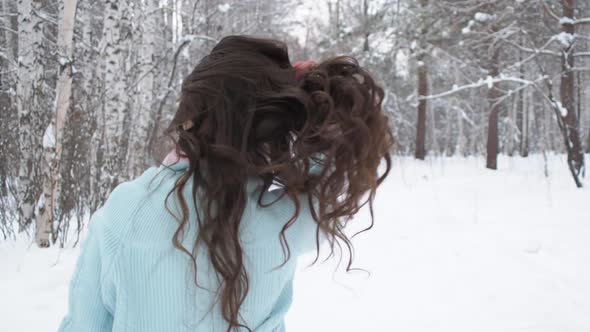 Stylish Young Woman Walking Towards Winter Forest