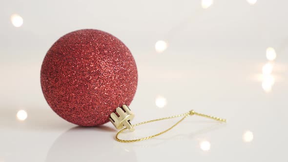 Round Christmas ornament on white background slow tilt 4K 2160p 30fps UltraHD  footage - Golden stri