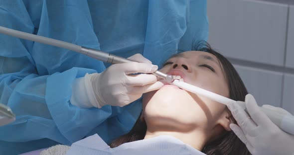 Woman undergo professional tooth whitening and ultrasound cleaning at dental clinic