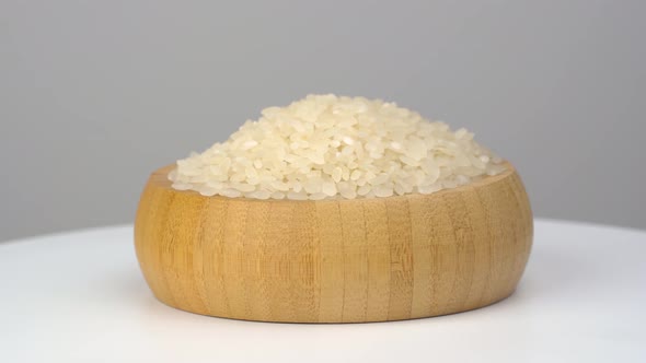 Raw rice grains on white background. 