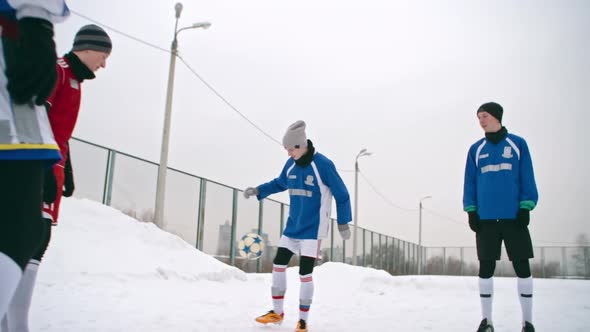 Teenage Soccer Players Handling a Ball