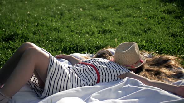 Child Lying on Blanket Having Picnic in Summer Park