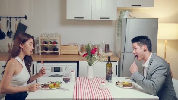 Asian young couple having dinner to celebrate valentine's day together.