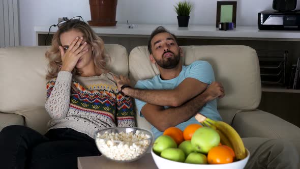 Couple Watching a Horror Movie at Night in Living Room