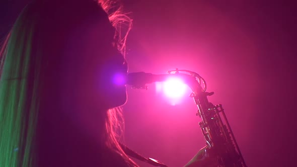 Young Sexy, Blonde Woman Dj in White Jacket and Black Top Playing Music Using Saxophone, Flipping