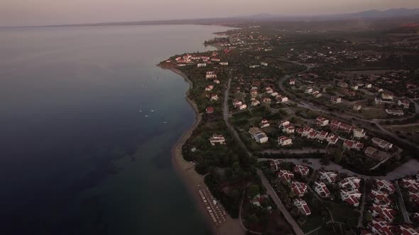 Aerial Shot of Cottages Along the Shoreline. Trikorfo Beach, Greece