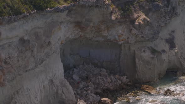 Rising Aerial Pan of Cliffs Cascading into the Water Near Loutraki Greece