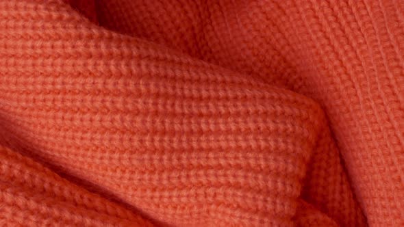 the Surface of a Knitted Orange Wool Sweater