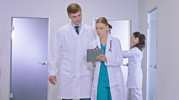 In the Large Hospital Corridor in Front of the