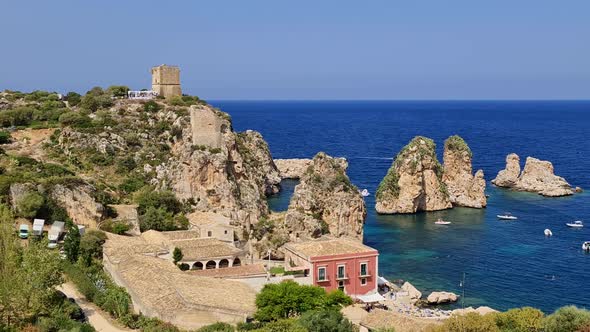 Stunning zoom-in panoramic view of Stacks or Faraglioni of Scopello with Tonnara tuna factory and To