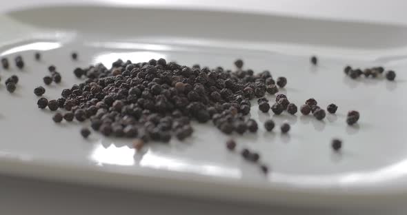 Peppercorns on a plate for cooking with spice