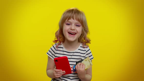 Child Kid Girl Use Mobile Cell Phone and Plastic Credit Bank Cards Browsing Say Wow Yes Great Win