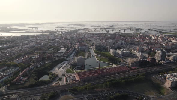 Aerial Paralax Panoramic view over Ria de Aveiro canals and Downtown glowing sun