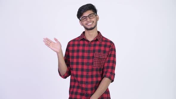 Young Happy Bearded Indian Hipster Man Waving Hand