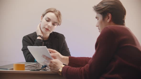 Man  Telling What Is on the Documents and the Girl Is Listening