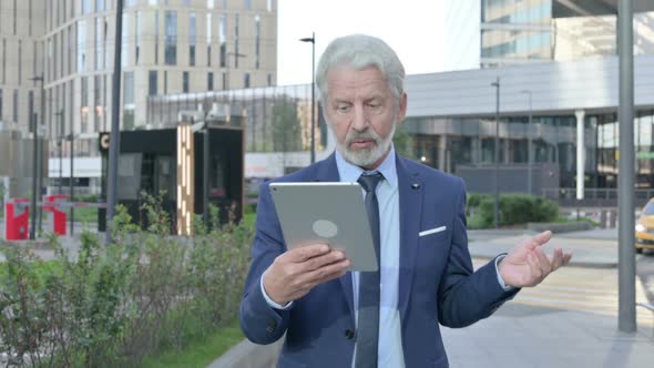 Walking Old Businessman Talking on Video Call on Tablet