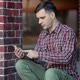 Urban portrait of serious handsome millennial man using mobile phone - VideoHive Item for Sale