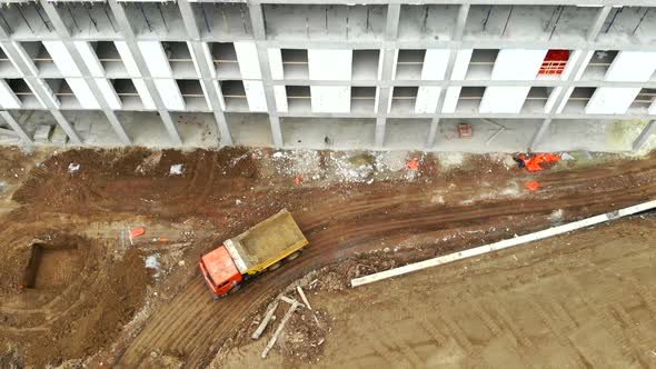 The View From the Top. An Empty Truck Drives Past Unfinished Construction.