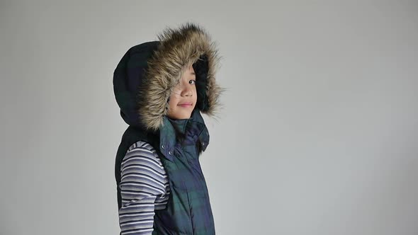 Cute Asian Girl In Winter Clothes On Gray Background Isolated