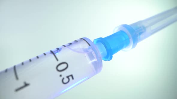 Close-up of a New Disposable Syringe with a Closed Cap on a Needle. The Medicine for the Virus Is