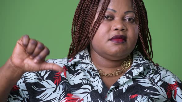 Overweight Beautiful African Woman Against Green Background