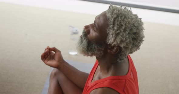 Video of african american senior man meditating