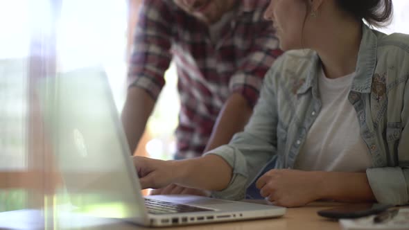 Men and women using laptop