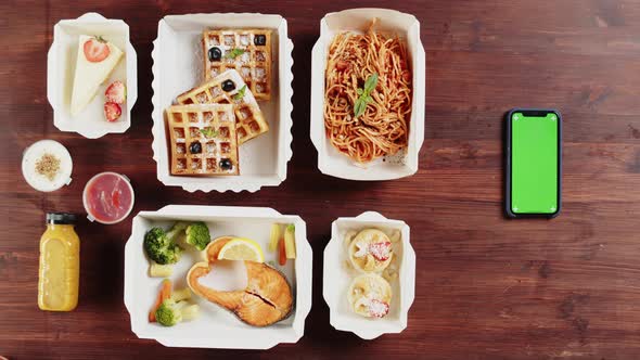 Food Delivery App Take Away Meals in Disposable Containers on Wooden Table