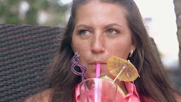 Lady Drinks Watermelon Beverage on Lounge Chair in Hotel