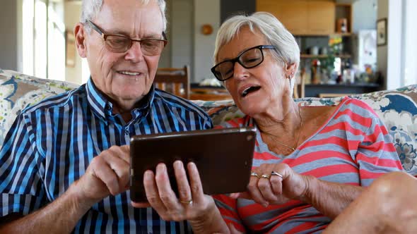 Senior couple making video call on digital tablet 4k