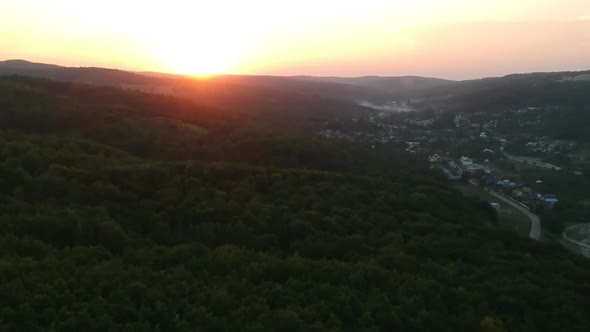 Drone view of sunset over forest in Romania