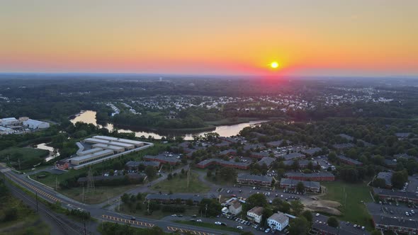 Aerial View of Residential Town Areas Along the River with Private Houses in Skyline Sunset
