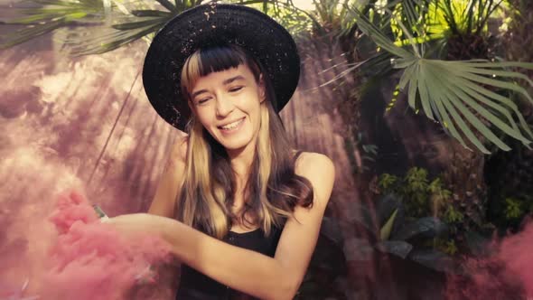 Close Up in Motion a Charming Young Woman in a Straw Hat Having Fun Hslow Olding in Her Hand a Smoke