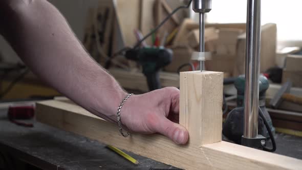 Male Carpenter Works in the Workshop